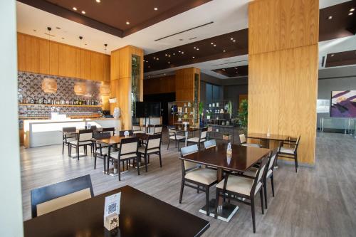 a restaurant with tables and chairs and a bar at AZZ Valencia Congress Hotel & Spa in Paterna
