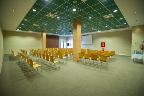 a conference room with a table and chairs in it at AZZ Valencia Congress Hotel & Spa in Paterna