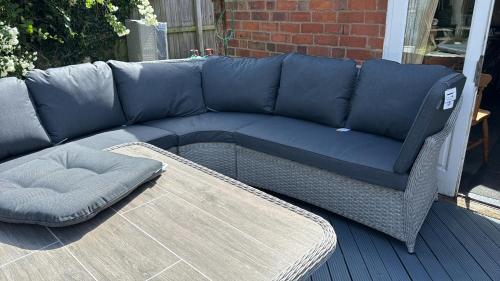 a blue couch sitting on top of a patio at Anita's Home in Kidderminster in Kidderminster