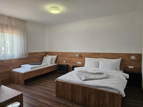 a bedroom with two beds and a couch at Hostel PREMIUM in Derventa