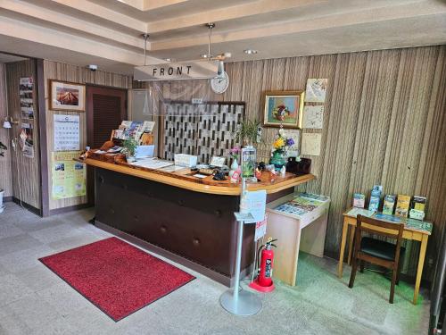 a store with a front counter with a red rug at Plaza Inn Kawaguchiko in Fujikawaguchiko