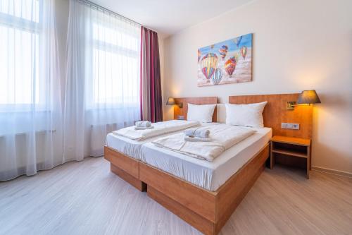 Postel nebo postele na pokoji v ubytování Best Western Hotel Dreiländerbrücke Weil am Rhein / Basel