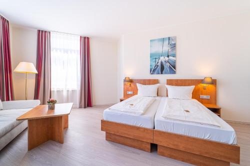 Postel nebo postele na pokoji v ubytování Best Western Hotel Dreiländerbrücke Weil am Rhein / Basel