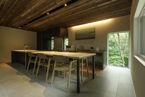 a kitchen with a table and chairs in a room at 山郷 Villas in Nature in Otaru
