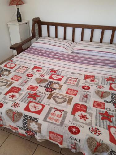 a bed with a christmas quilt on it at holiday house MAURIZIO in Formia