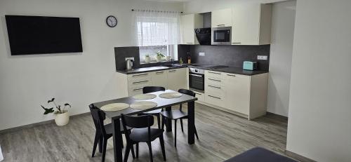 a kitchen with a table and chairs in a room at apartmány Miška Mirkovice in Mirkovice
