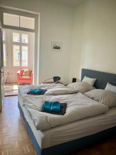 a bedroom with a large bed with blue pillows on it at Ferienwohnung Martin Hoop in Bautzen