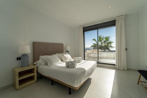 a bedroom with a bed with a view of the ocean at Estepona Holiday Hills in Estepona