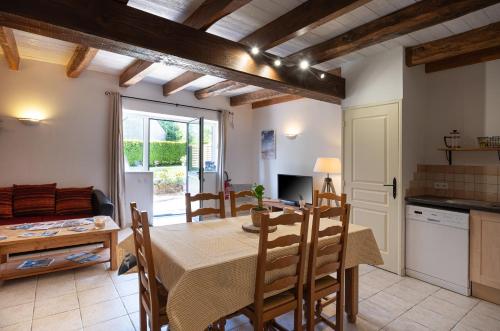 une cuisine et une salle à manger avec une table et des chaises dans l'établissement Domaine de Lestroué - Île de Groix, à La Vraie-Croix