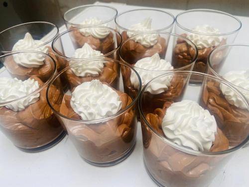 a group of glass cups filled with chocolate and whipped cream at L'auberge de l'abbaye in Sorde-lʼAbbaye