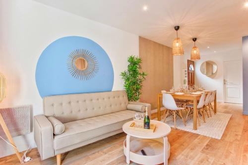 a living room with a couch and a table at Charming seaside house in Varaville