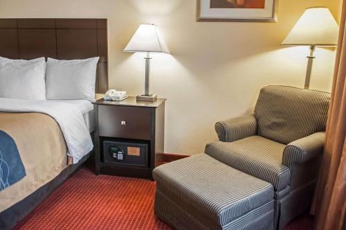 a hotel room with a bed and a chair at Quality Inn Rio Rancho - Albuquerque North Valley in Rio Rancho