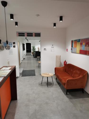 a living room with a couch and a table at PUBYLAND ROOMS & APARTMENTS in Rogatec