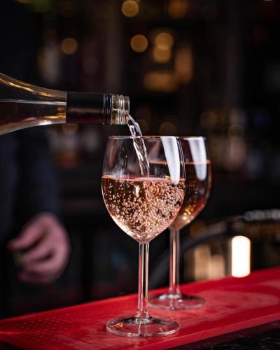 two glasses of wine on a table at DeiRa Hotel & Apartments in Prestwick
