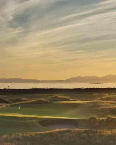 a view of a golf course at sunset at DeiRa Hotel & Apartments in Prestwick