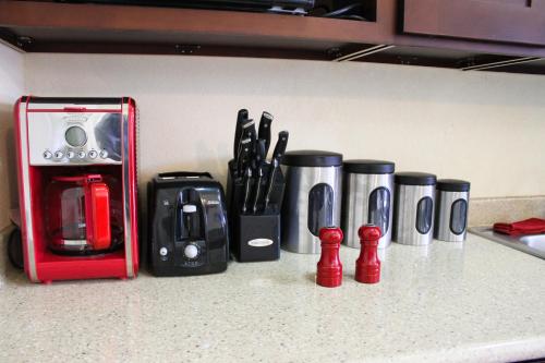 a kitchen counter with coffee cups and utensils at Eclipse Suite Guest Apartment in Kingston