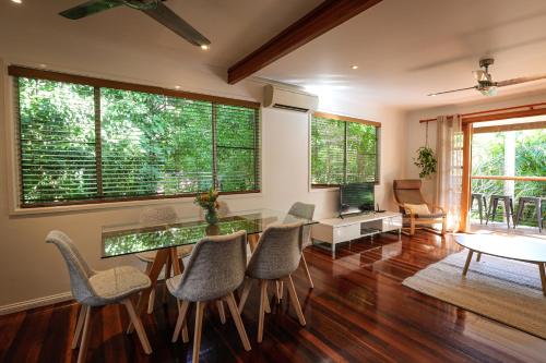 a dining room with a glass table and chairs at Regent Bower Cottage in Eagle Heights