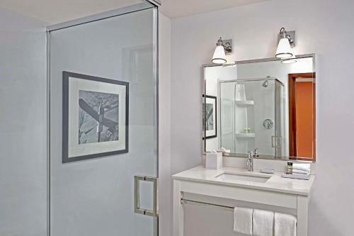 a bathroom with a sink and a mirror at Grand Park Hotel Vancouver Airport, Ascend Hotel Collection in Richmond