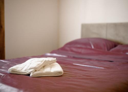 a white towel sitting on top of a bed at Brvnara Staničić in Arandjelovac