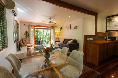 a living room with a glass table and chairs at Regent Bower Cottage in Eagle Heights