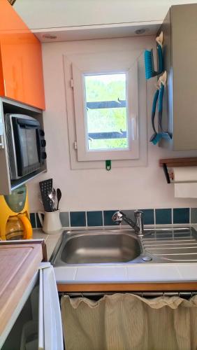 a kitchen with a sink and a window at Fenouillet in Hyères