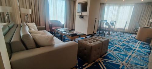 a living room with a couch and a table at Hotel Marine Plaza in Mumbai