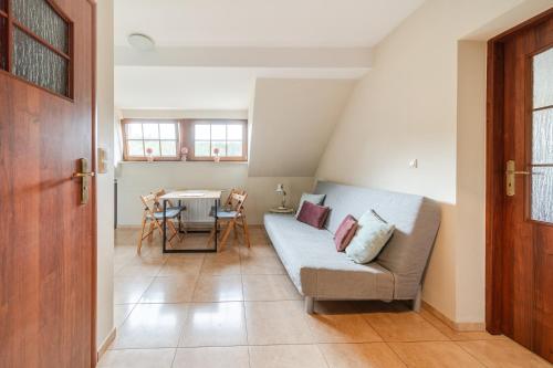 a living room with a couch and a table at Józefina Apartament's blisko centrum in Szklarska Poręba