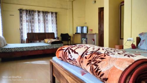 a room with three beds in a room with at Riwar Homestay in Mawlynnong