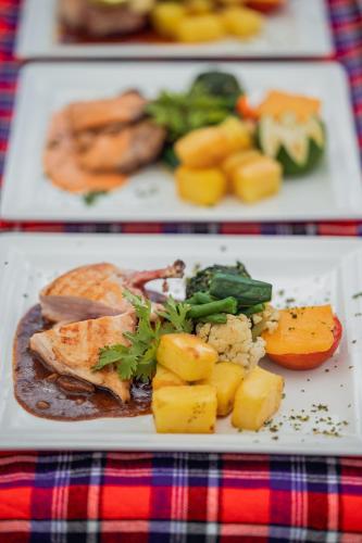 a plate of food with meat and vegetables on a table at Muthu Lake Naivasha Country Club, Naivasha in Naivasha