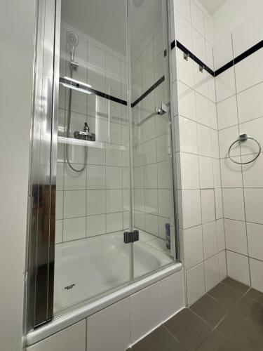 a shower with a glass door in a bathroom at IOS ArtPrg in Prague