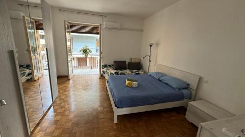 a bedroom with a bed with a blue comforter at Bartolo Health and Wellness in Cagliari