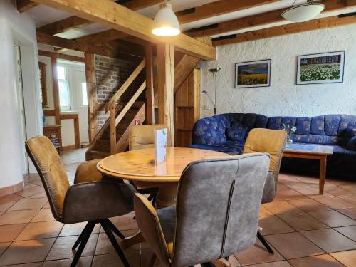 a living room with a wooden table and chairs at Reethäuser auf Rügen in Middelhagen