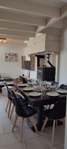 - une salle à manger avec une table et des verres à vin dans l'établissement So'Home, à Saint-Père