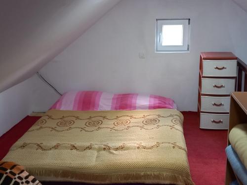 a small bedroom with a bed and a dresser at Jezerca Wild Beauty in Pluzine