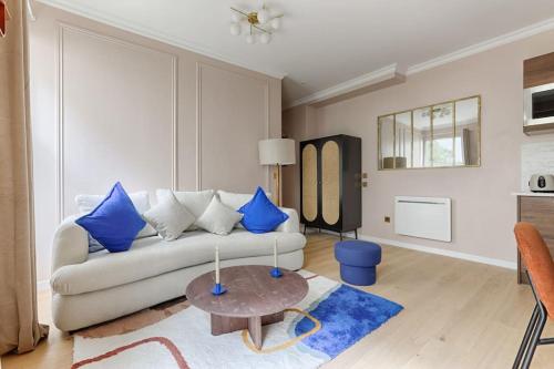 a living room with a couch and a table at MyKeypers - Luxury Flat 3BR 8P with Jacuzzi - Haussmann in Paris