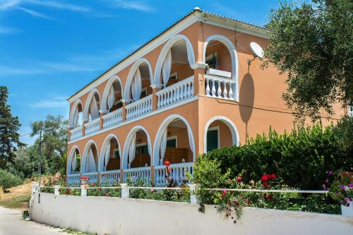 a large house with a white fence in front of it at Angeliki in Vitalades