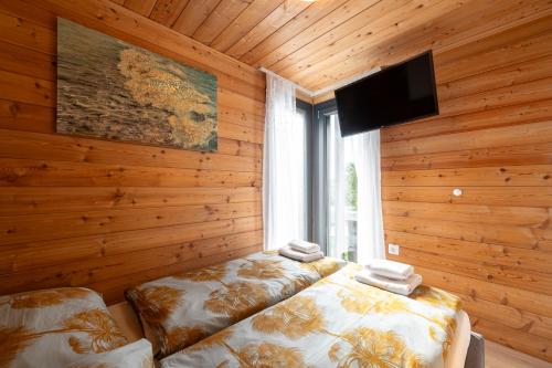 a room with two beds and a flat screen tv at Sun and Sky in Slano