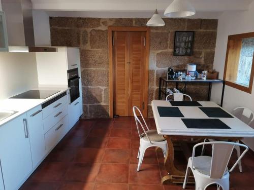 a kitchen with a table and chairs in a room at Villa Cristina in Nigrán