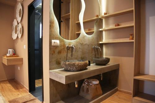 a bathroom with two sinks and a mirror at Foga Hebrus in Ksamil