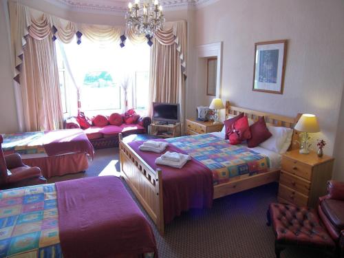 a bedroom with two beds and a desk at Ardleigh House in Edinburgh