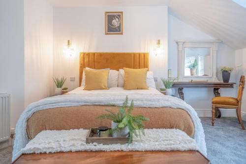 a bedroom with a large bed and a table and a desk at Gorgeous New 1 Bedroom Penthouse Flat in Morecambe
