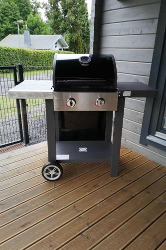 a barbecue grill sitting on a deck on a porch at Holiday Home Ferienhaus Barbara by Interhome in Enspel