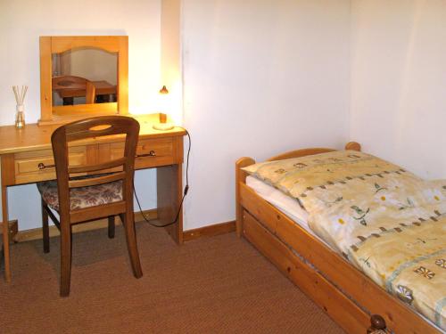 a bedroom with a bed and a desk and a chair at Holiday Home Marta by Interhome in Červený Kostelec