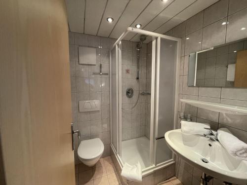 a bathroom with a shower and a toilet and a sink at Holiday Home Zentral by Interhome in Schnann