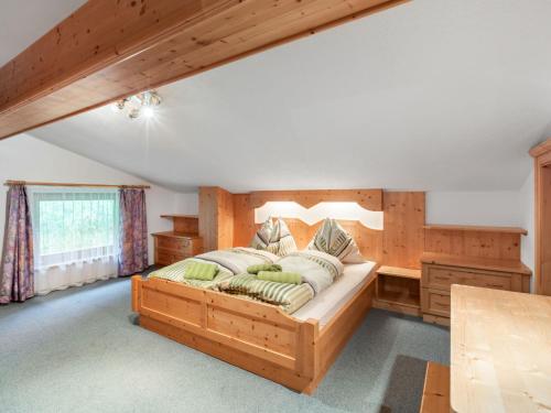 a bedroom with a large wooden bed in a room at Apartment Prieslern-2 by Interhome in Dorf