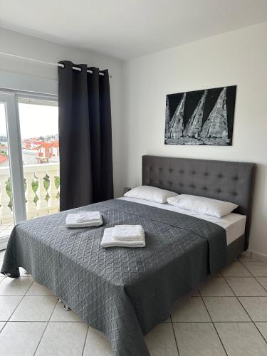 a bedroom with a bed with two towels on it at Apartments Jareb in Tribunj