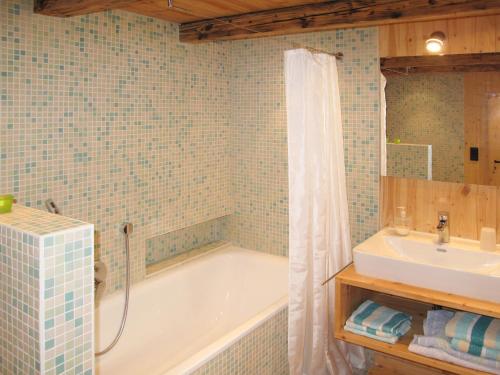 a bathroom with a tub and a sink at Holiday Home Bistenhof by Interhome in Hinterzarten
