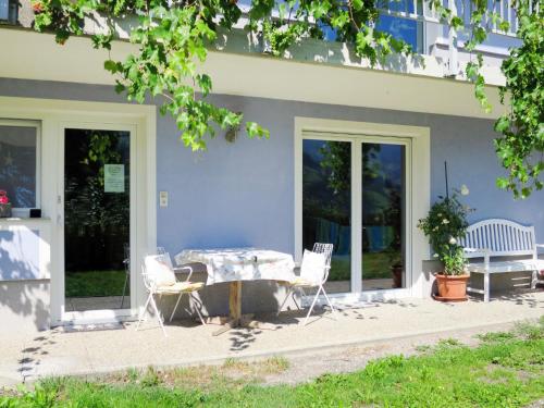 a table and chairs in front of a house at Apartment Bair - MHO535 by Interhome in Hippach