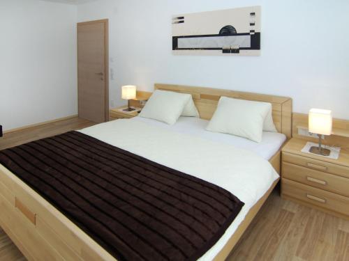 a bedroom with a large bed with two night stands at Holiday Home Schiestl by Interhome in Ramsau