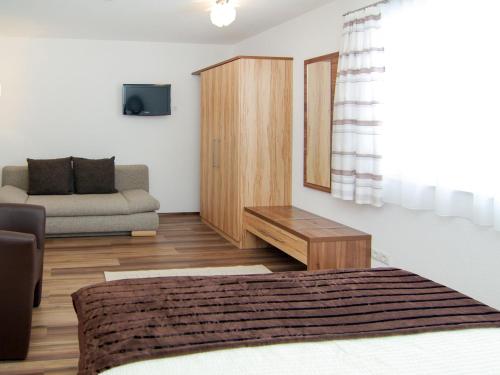 a living room with a bed and a couch at Holiday Home Schiestl by Interhome in Ramsau